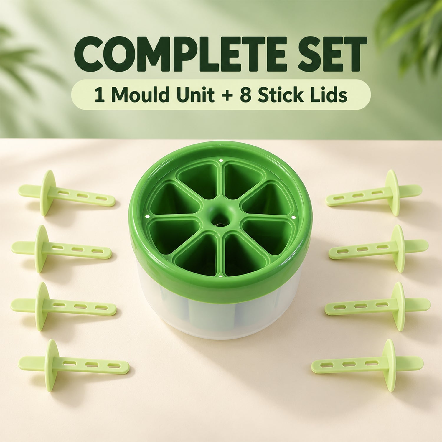 A green and white round plastic ice cream mold with eight green stick lids arranged around it on a light brown surface.