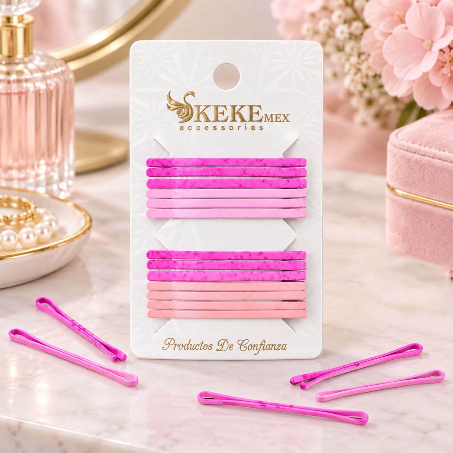 A pack of sixteen pink and magenta bobby pins on a card, with several loose pins scattered on a marble surface.