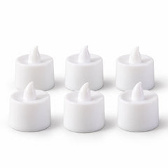 Six white flameless tealight candles with realistic flame-shaped tops are neatly arranged in two rows on a plain white