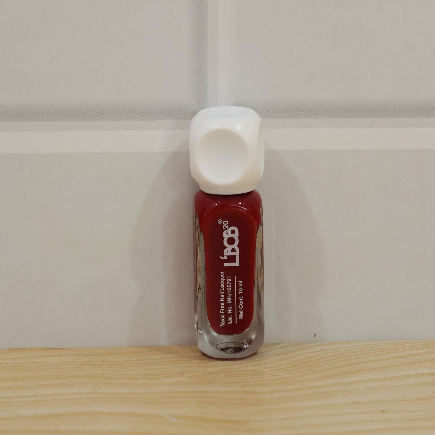 Wine maroon nail polish applied on nails for a complete manicure
