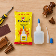 A yellow Fixwell glue packet, white glue bottle, and accessories are arranged with repair tools on a wooden surface.