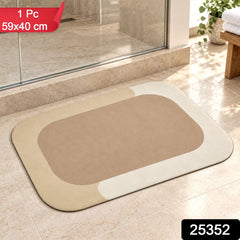 A rectangular bath mat with rounded corners, featuring a beige center and a light cream border, rests on tiled â€“ view 2