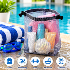 A grey mesh pouch with toiletries and blue goggles rests by a swimming pool.