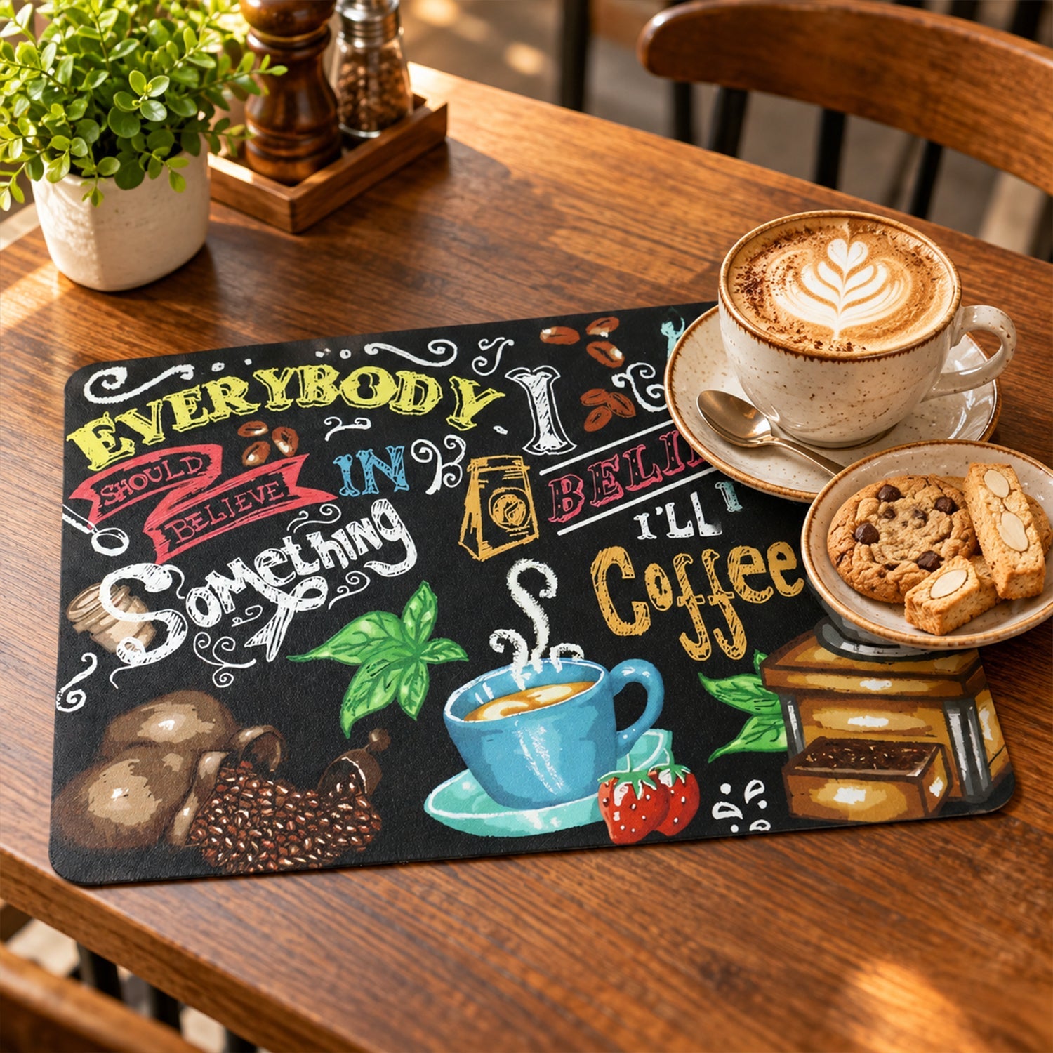 Coffee-themed mat on a wooden table with a cup of latte art coffee and cookies on a small plate.
