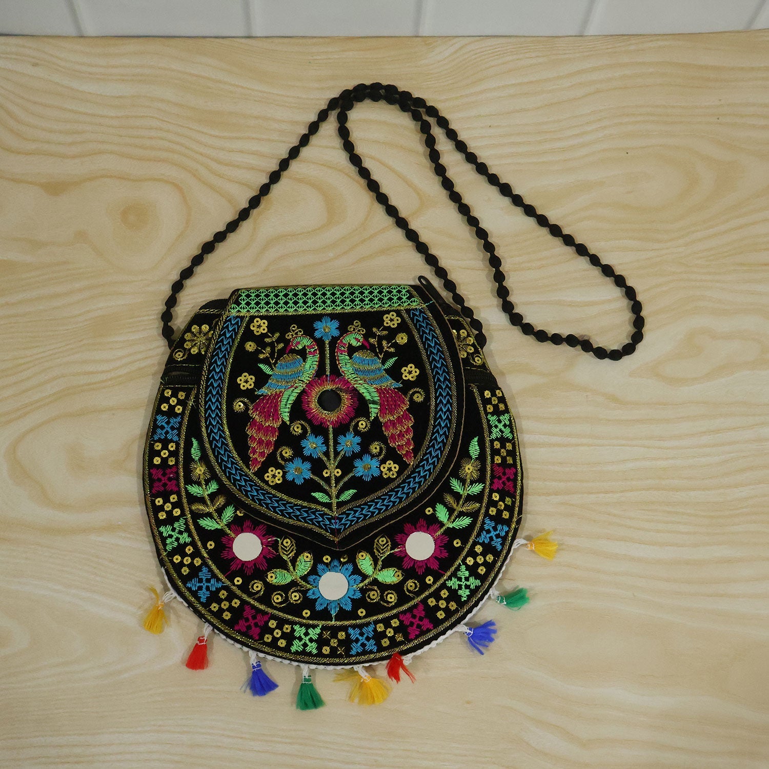 Woman carrying traditional peacock embroidered sling purse
