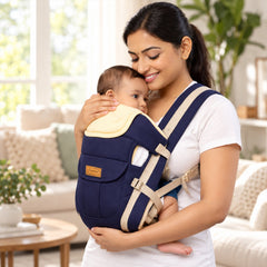 A smiling woman holds a baby close in a navy and beige baby carrier with a padded headrest.