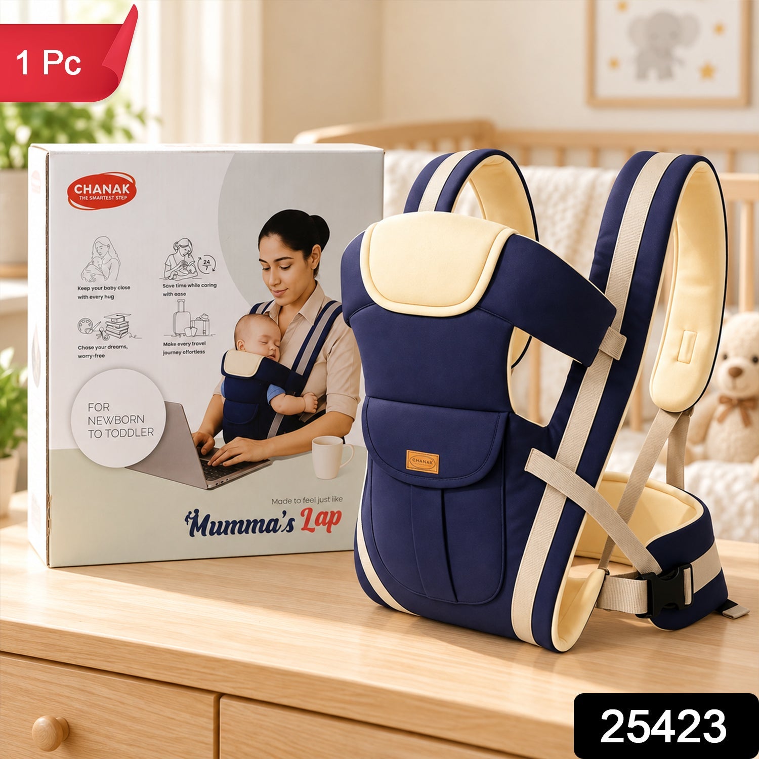 A navy and beige baby carrier stands next to its white and red product box on a wooden surface.