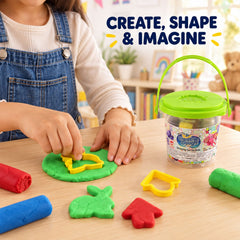 A child's hands press a yellow cutter into green dough, with other colorful dough pieces and cutters nearby.