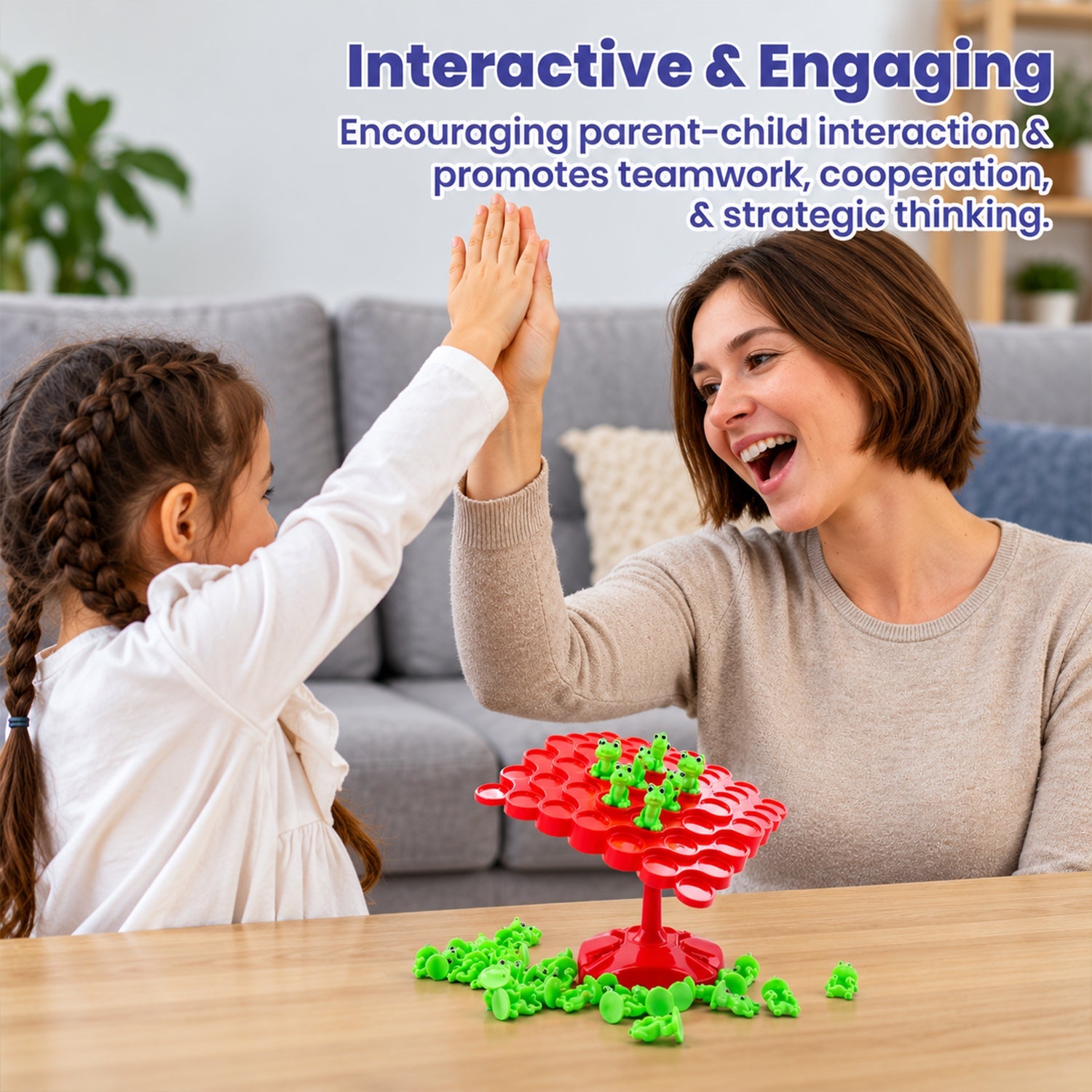A mother and child smiling while playing the balancing game, with the red board and green frogs on a wooden table.