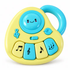 Close-up of the yellow and blue musical toy with a happy face, four keys, and a blue handle.