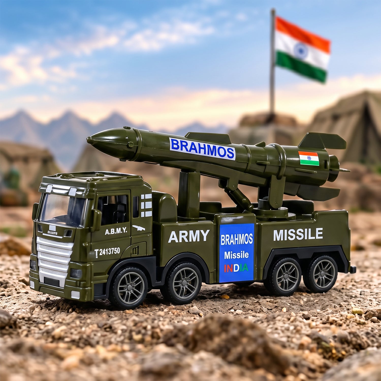A green toy army truck with a missile launcher on its back sits on a dirt road under a blue sky with an Indian flag.