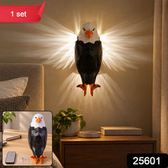 A geometric black and white eagle wall light with orange feet and beak, casting light on a bedroom wall.