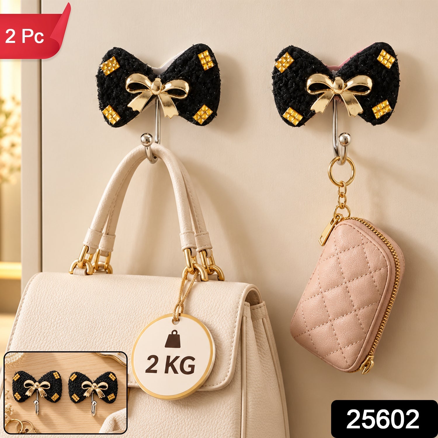 Two black bow-shaped hooks with gold accents, holding a white handbag with a 2 KG weight tag and a pink pouch.