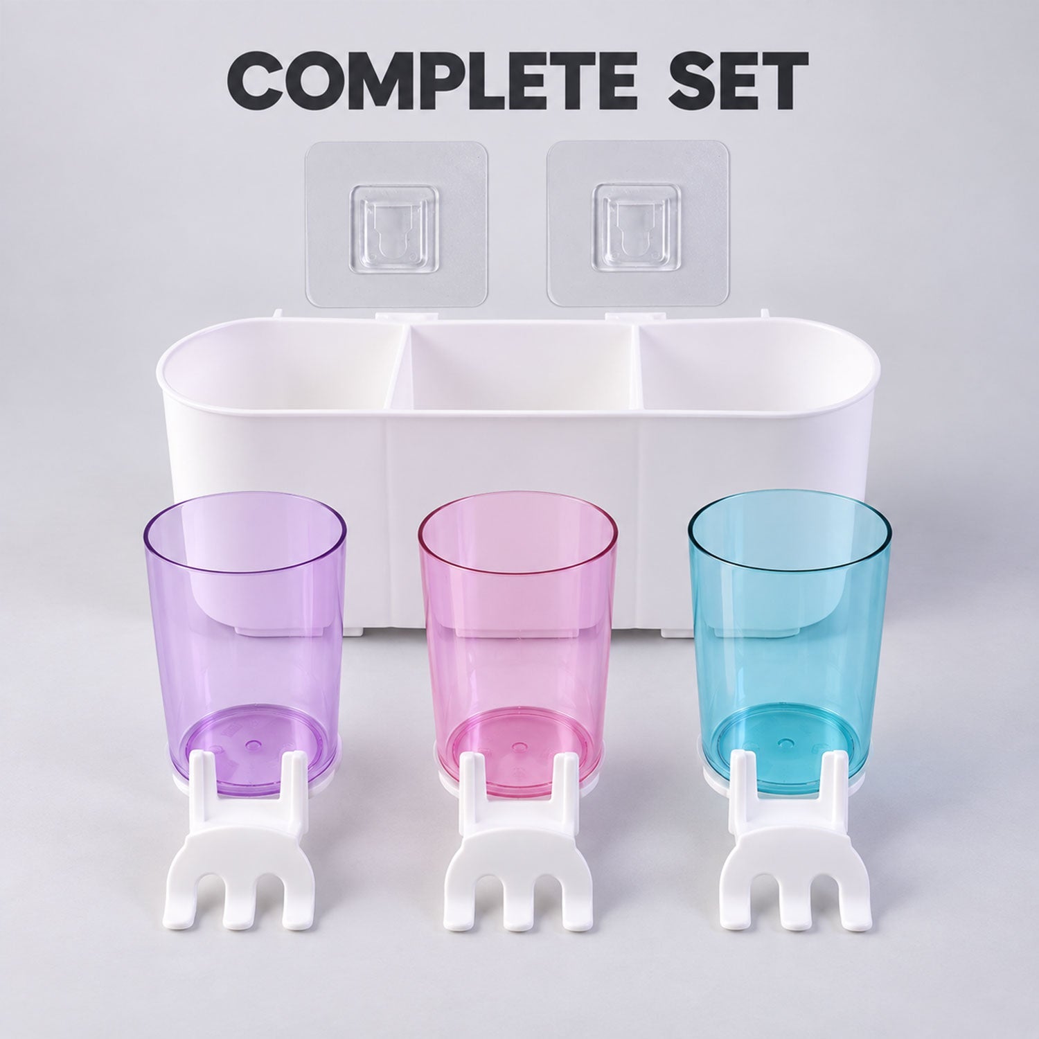 Complete set of a white wall organizer, three translucent cups, three toothbrush holders, and two adhesive hooks.
