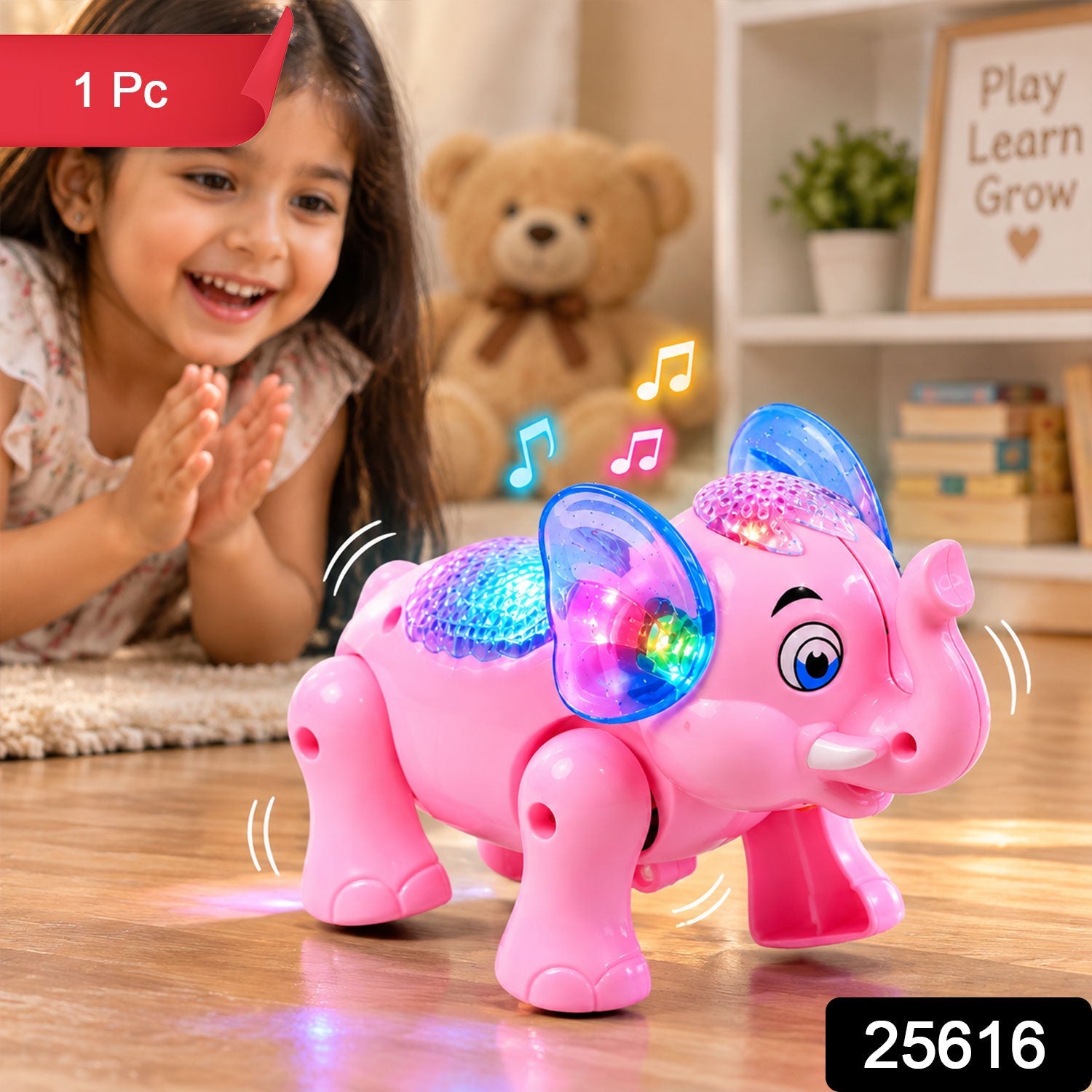 A child smiles at a pink elephant toy with bright lights on its back and ears, with a teddy bear in the background.