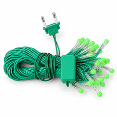 A coiled bundle of green LED string lights with a 2-pin plug and controller on a white surface.