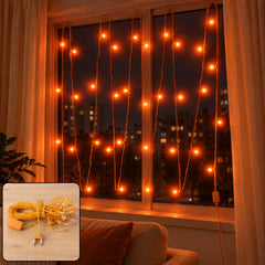 Orange LED curtain lights illuminate a window at night, with a coiled set of lights in the corner.