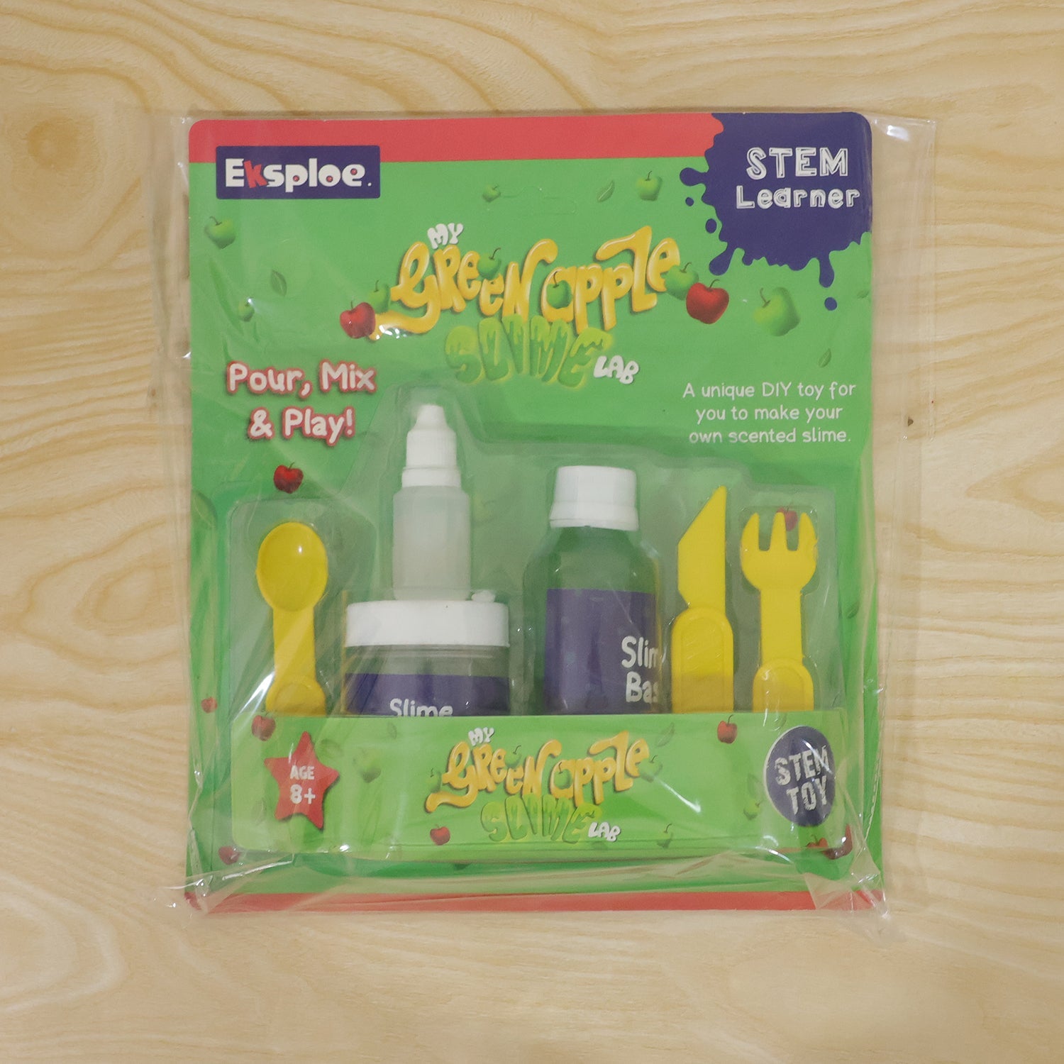 Kids hands stretching green apple scented slime