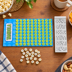 A close-up of the Tambola game board with yellow numbered circles, a ticket booklet, and loose yellow tokens on a wooden