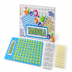 The Tambola game set is arranged on a white surface, showing the colorful box, blue number board, a stack of tickets, and