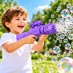 A young boy with curly hair smiles broadly while holding a purple bubble gun, surrounded by many colorful bubbles outdoors.