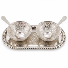 A silver-plated serving set with two decorative bowls and two spoons resting on an oval tray, against a white background.
