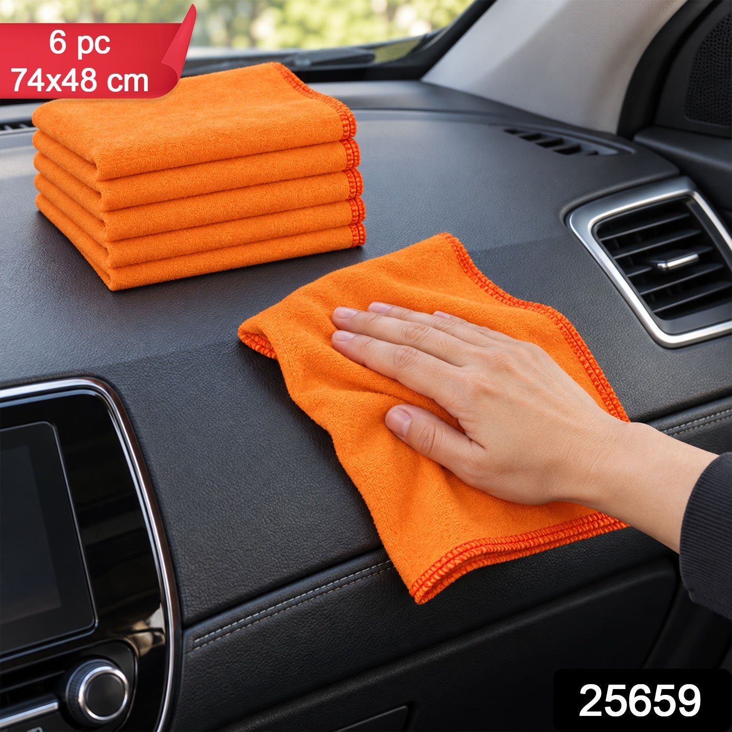A hand cleans a car's interior with an orange microfiber cloth, with a stack of five identical cloths beside it.
