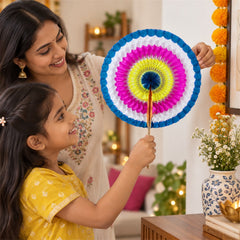A smiling woman and young girl holding a colourful paper hand fan with a wooden stick, surrounded by festive decorations and