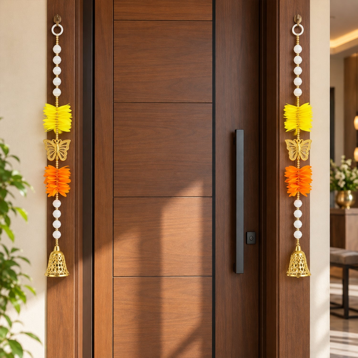 Two vibrant door hangings, each featuring yellow and orange paper flowers, a golden butterfly, and a bell, flanking a modern