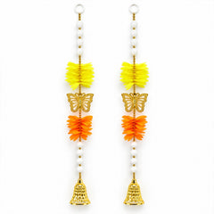 Two identical door hangings, each with yellow and orange accordion-fold flowers, a golden butterfly, and a bell, arranged