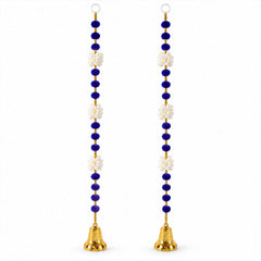 Two identical decorative hangings, each featuring blue pom-poms, white floral shapes, and a golden bell, are displayed on a