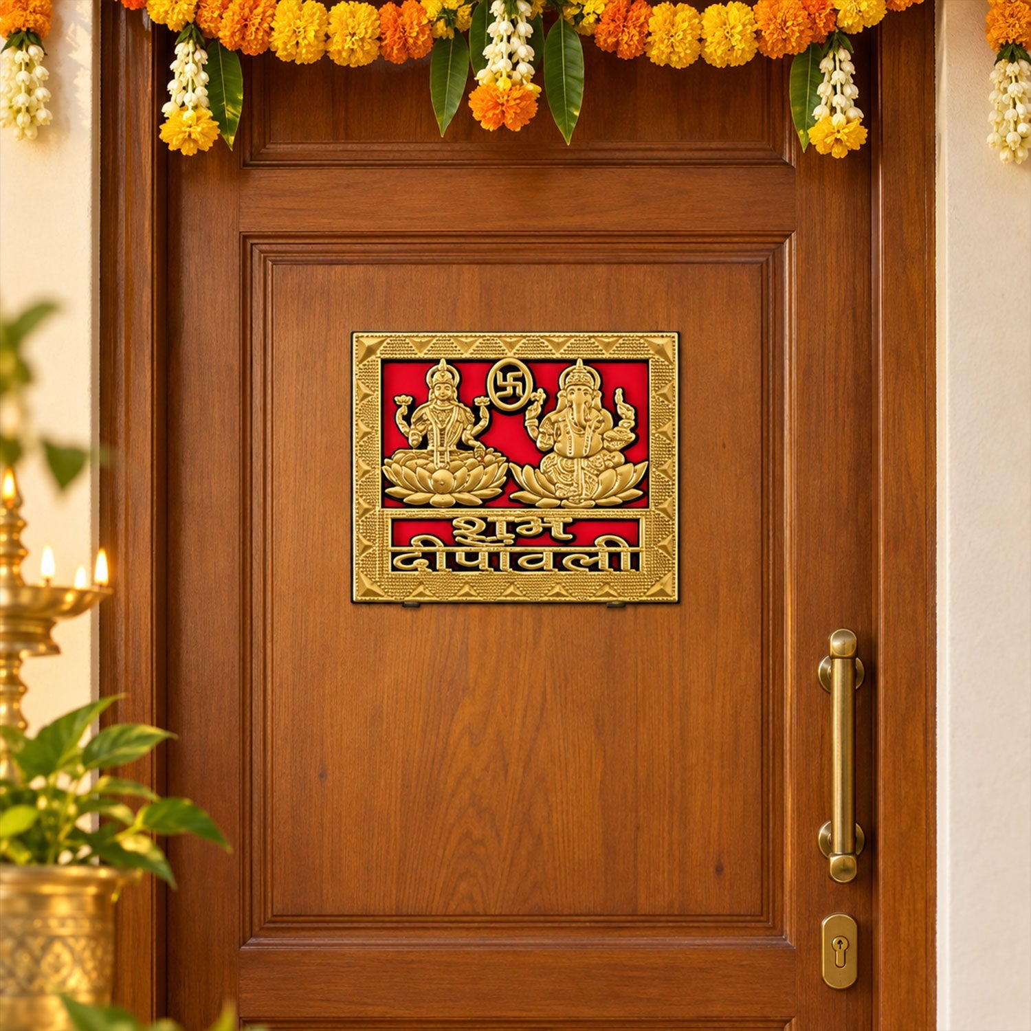 A square golden sticker featuring Lakshmi and Ganesha is affixed to a brown wooden door adorned with marigold garlands.