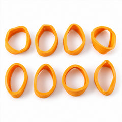 Eight individual orange silicone wheel covers are arranged neatly on a clean white surface.