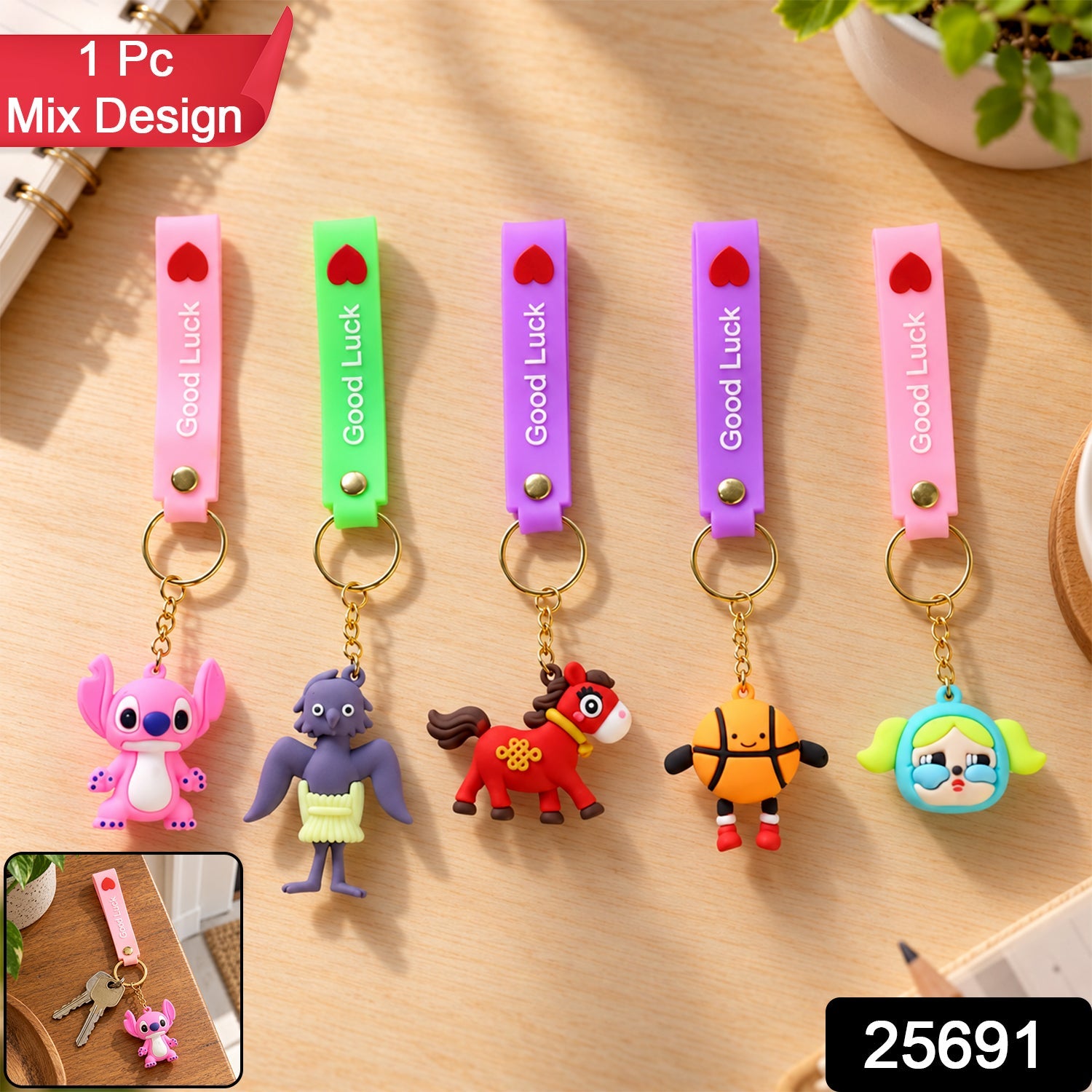 Five colorful silicone keychains with various cartoon character charms are displayed on a wooden desk, with a small inset