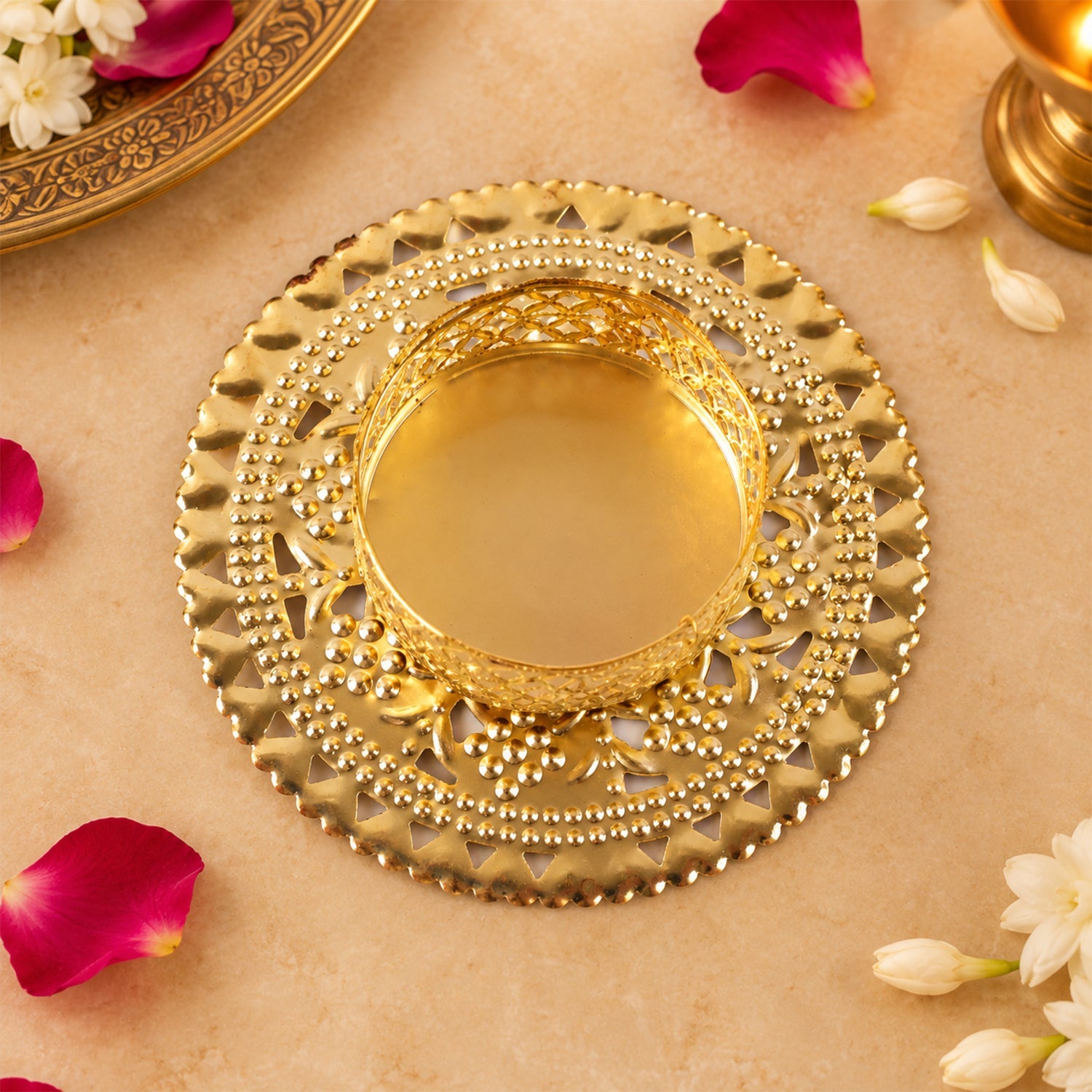Top view of gold tone metal jali tealight holder with round base