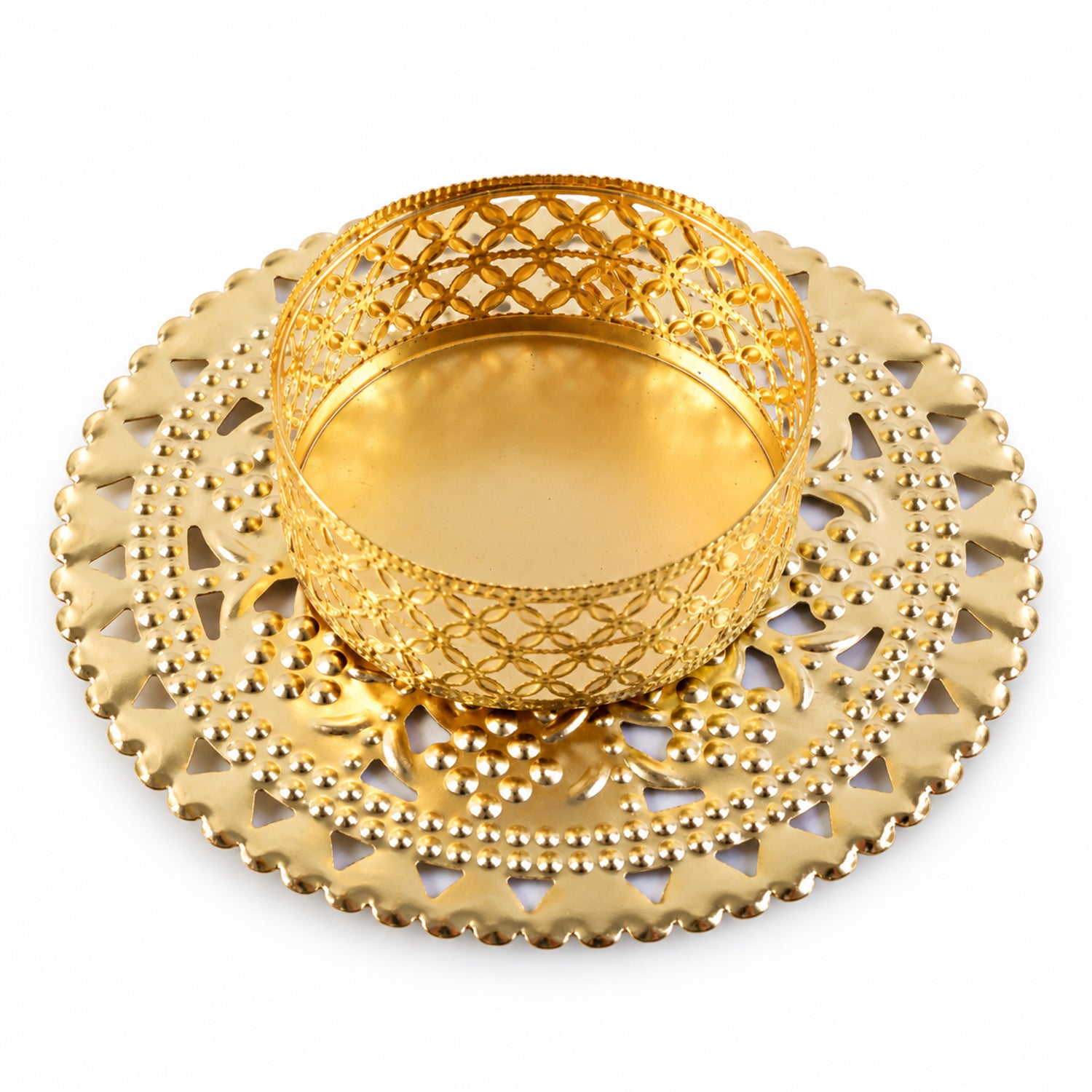 Gold tone metal jali tealight holder from a slightly elevated angle on white