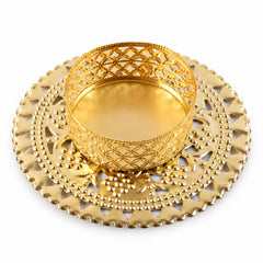 Gold tone metal jali tealight holder from a slightly elevated angle on white