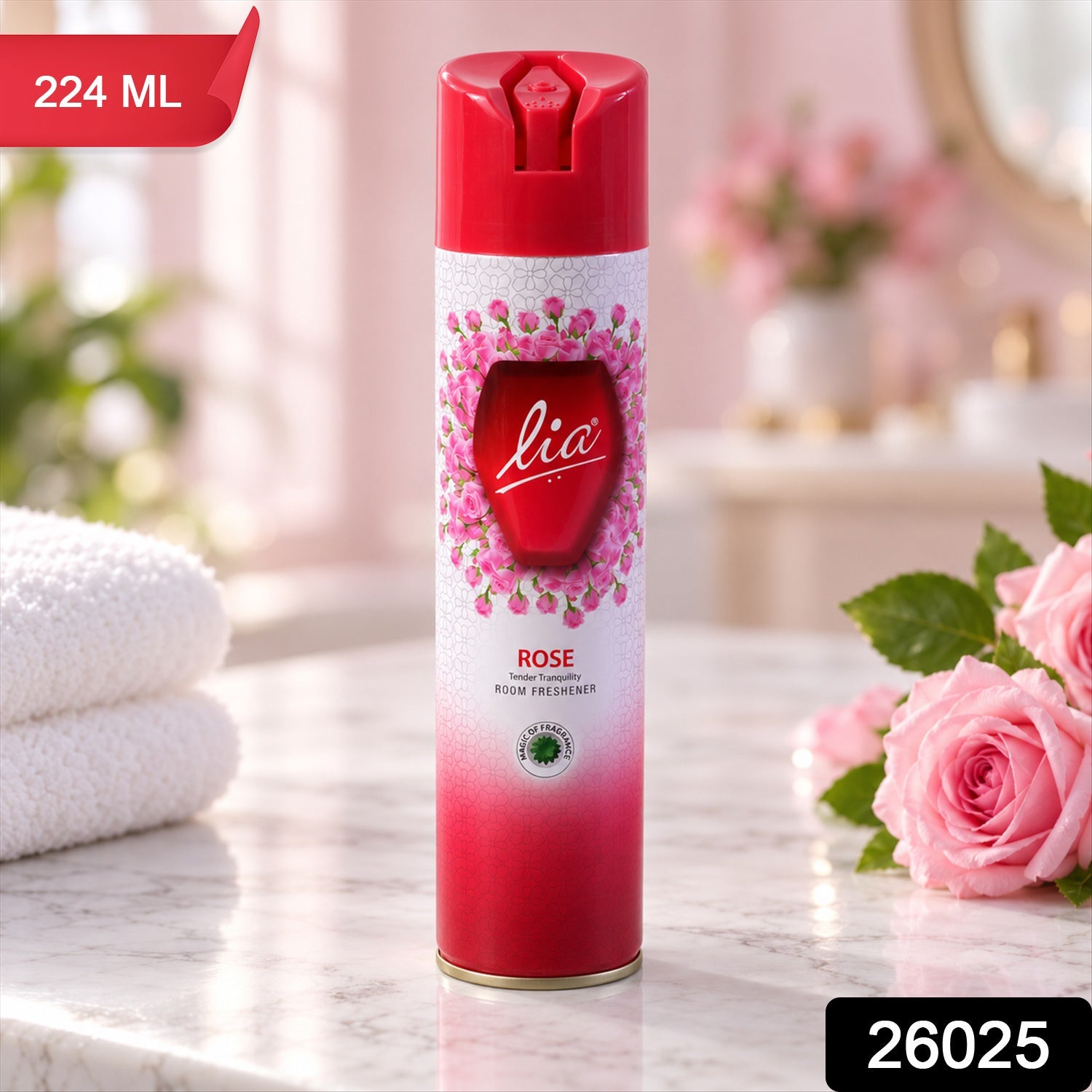 Red room freshener spray can with a pink rose pattern, displayed on a marble countertop beside folded white towels.