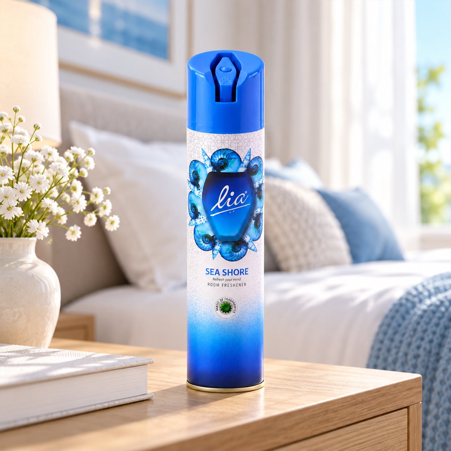 A blue and white aerosol spray can with a seashell design sits on a wooden nightstand in a bedroom.