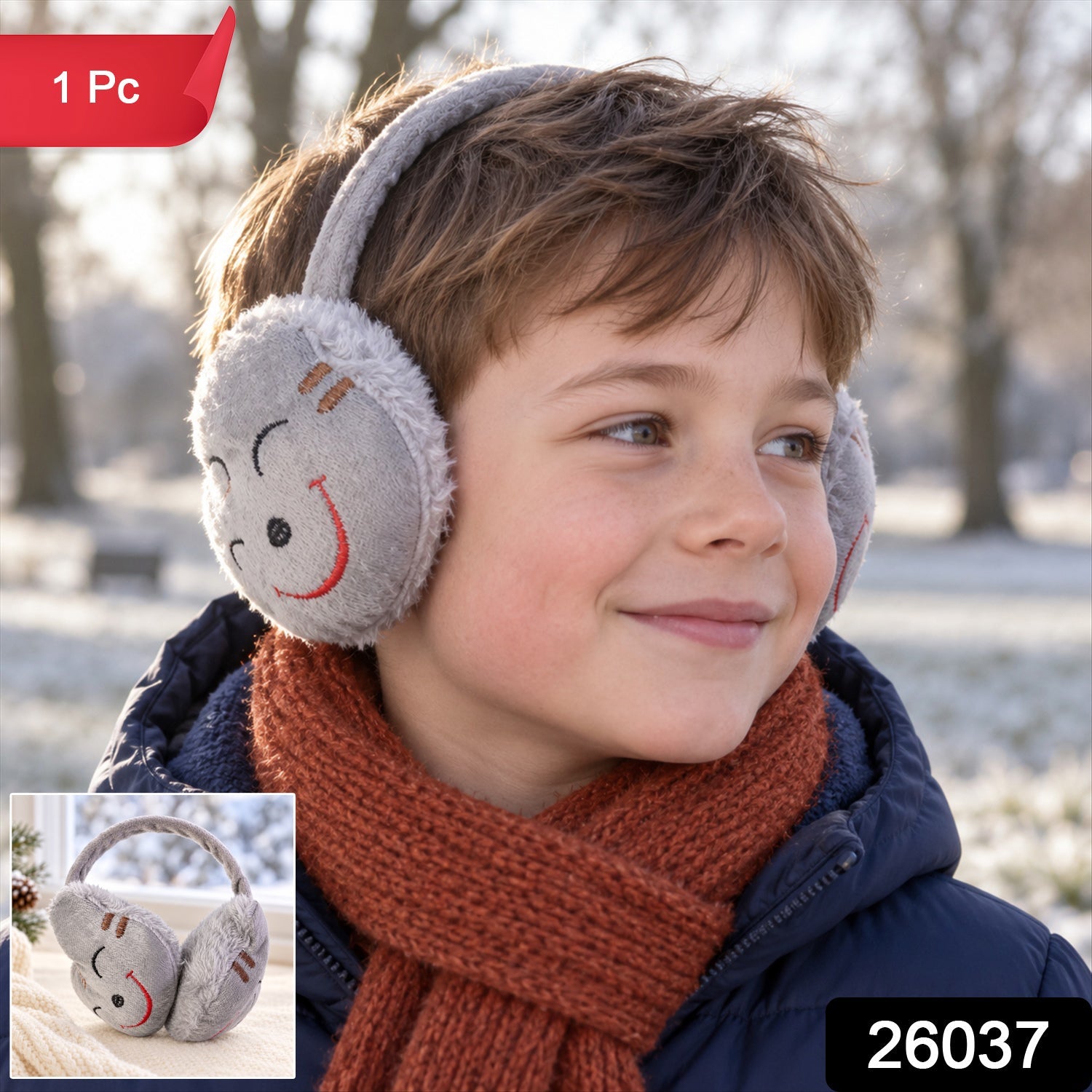 A boy with grey plush earmuffs featuring a red smiley face, a blue jacket, and an orange scarf smiles in a snowy landscape.