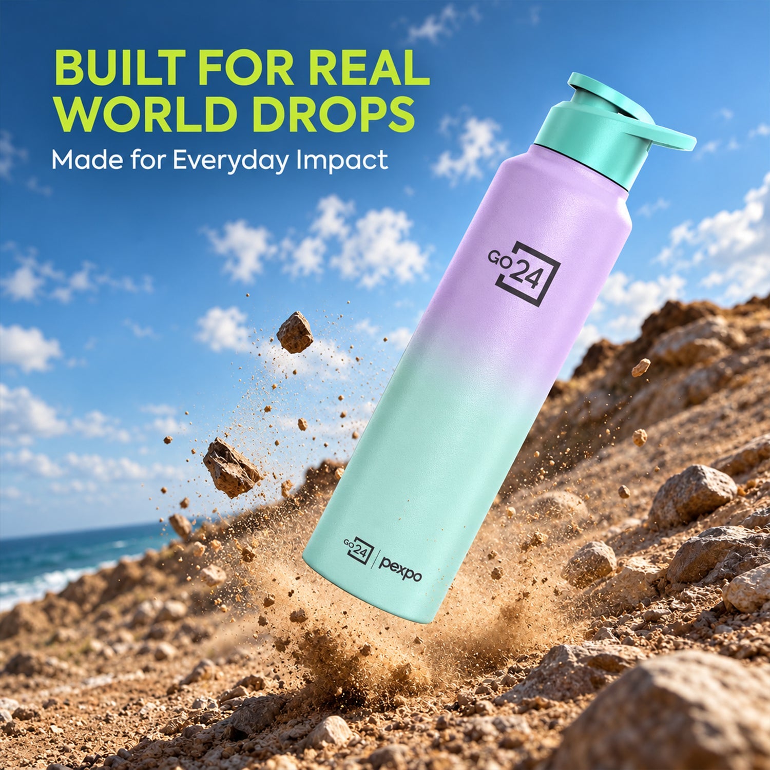 The ombre purple and mint water bottle is shown mid-air, surrounded by dirt and rocks, against a blue sky with clouds.