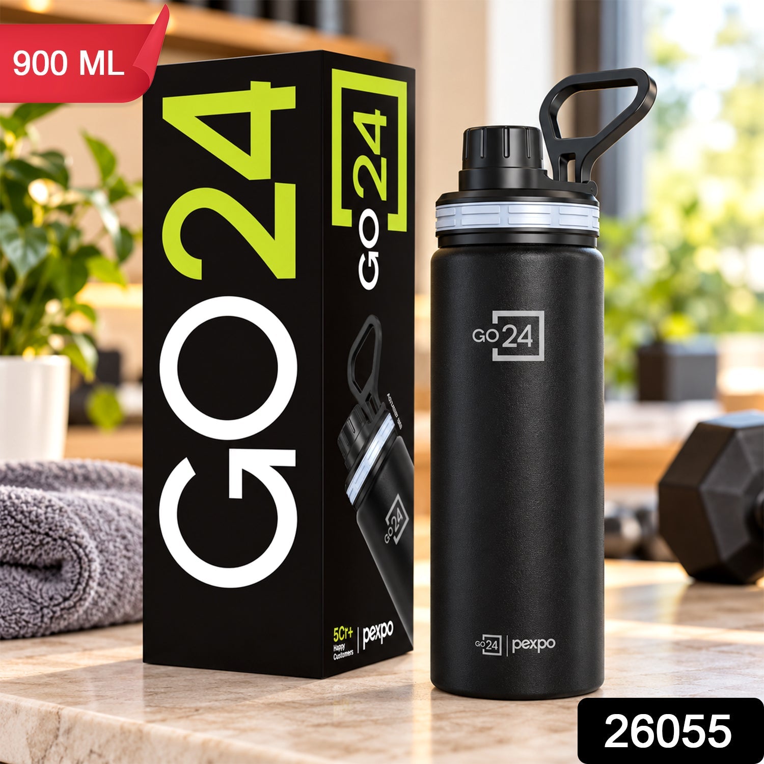 Black stainless steel bottle with its box, a grey towel, and a dumbbell in a bright room.