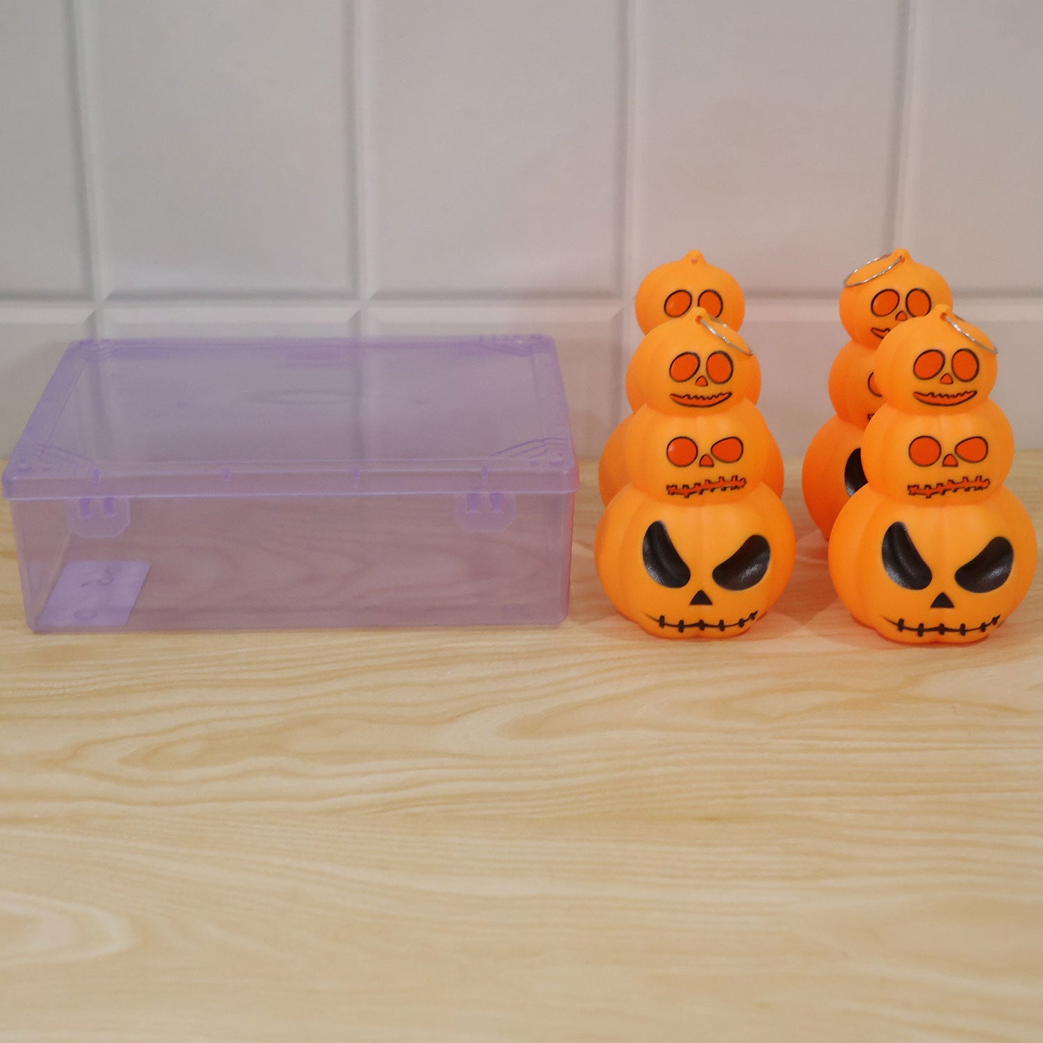 Halloween 3 Layer Pumpkin LED Hanging Light next to its plastic packaging