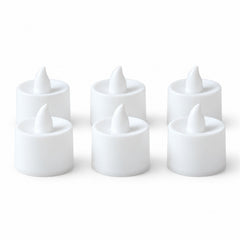 Six white flameless LED tealight candles, unlit, with a pointed top, neatly arranged on a plain white background.