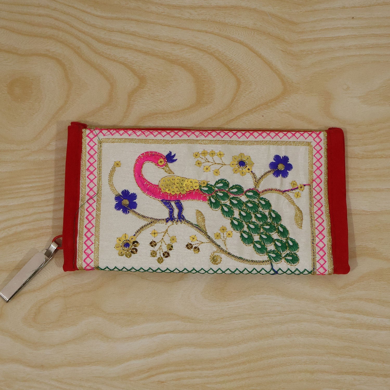 Woman holding the peacock embroidered clutch wallet during use