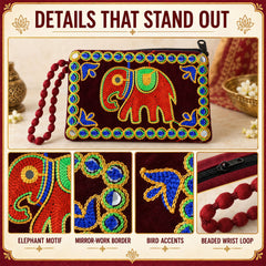 A dark red velvet clutch purse with an embroidered elephant, mirror work border, bird accents, and a beaded wrist loop.