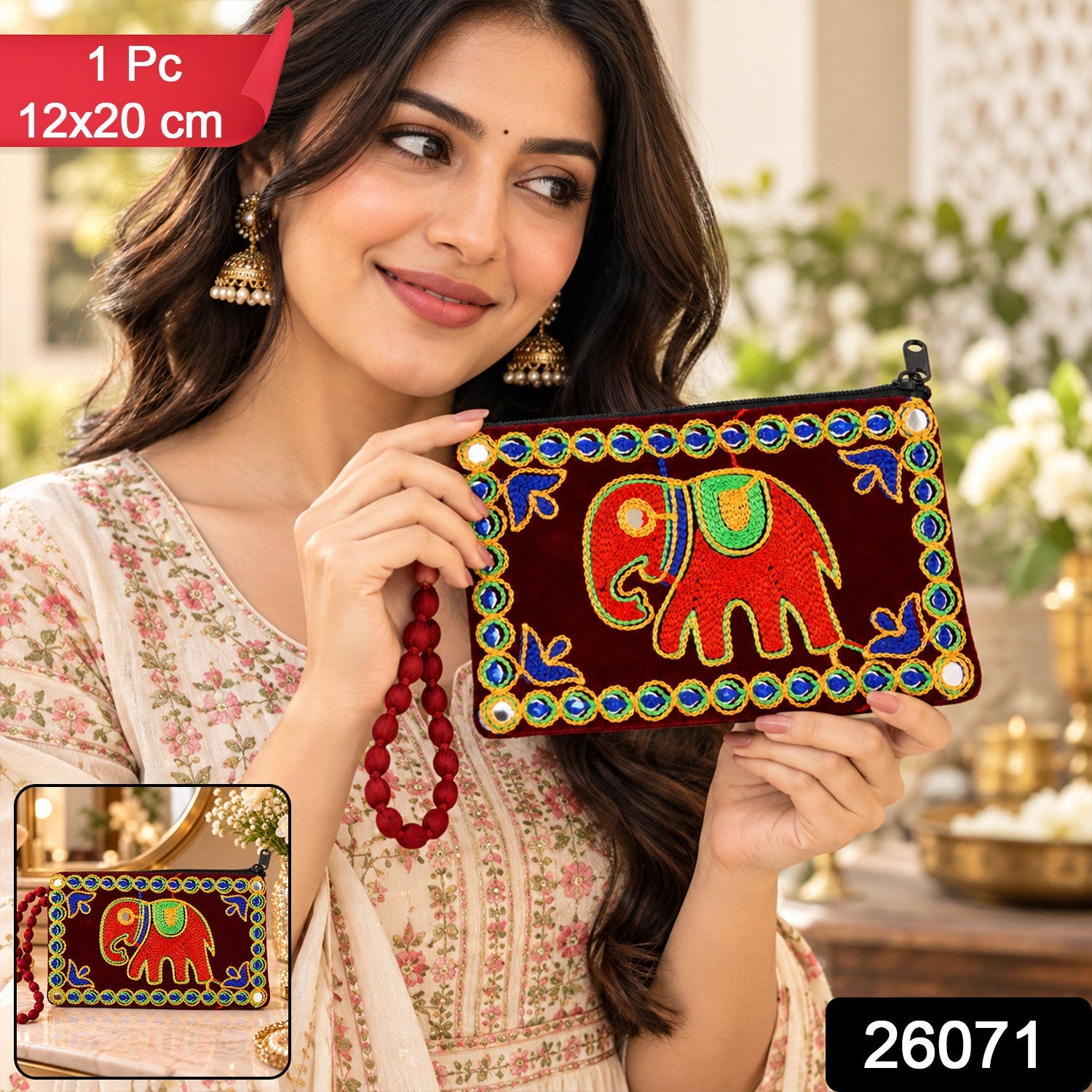 A woman holds a dark red velvet clutch purse featuring a colorful elephant design and beaded border, with product details