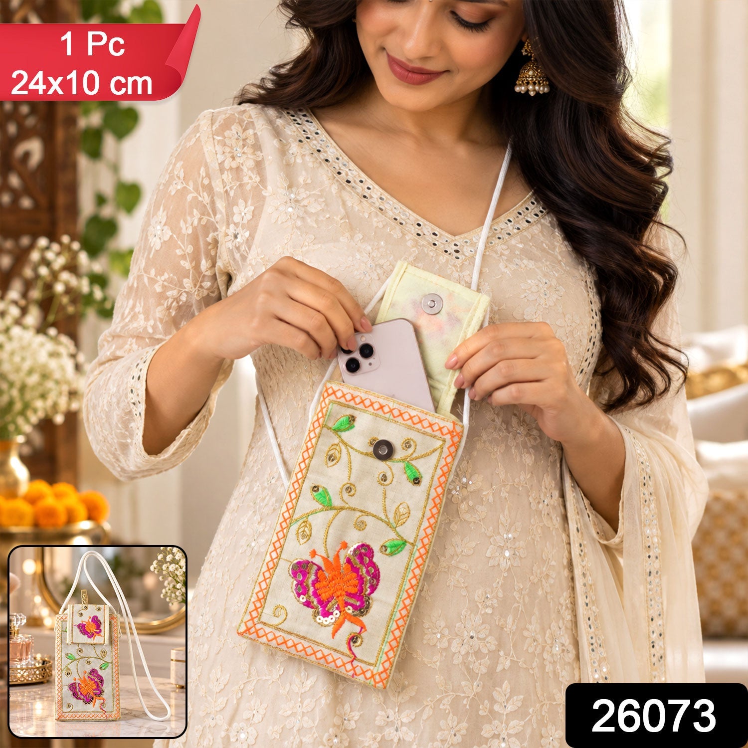 Woman inserting a phone into a white embroidered pouch with a butterfly design, wearing a cream dress.