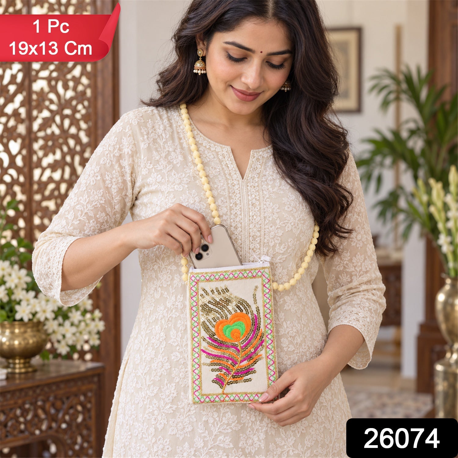 A woman in an off-white kurta smiles while holding a cream phone pouch with a vibrant peacock feather design.