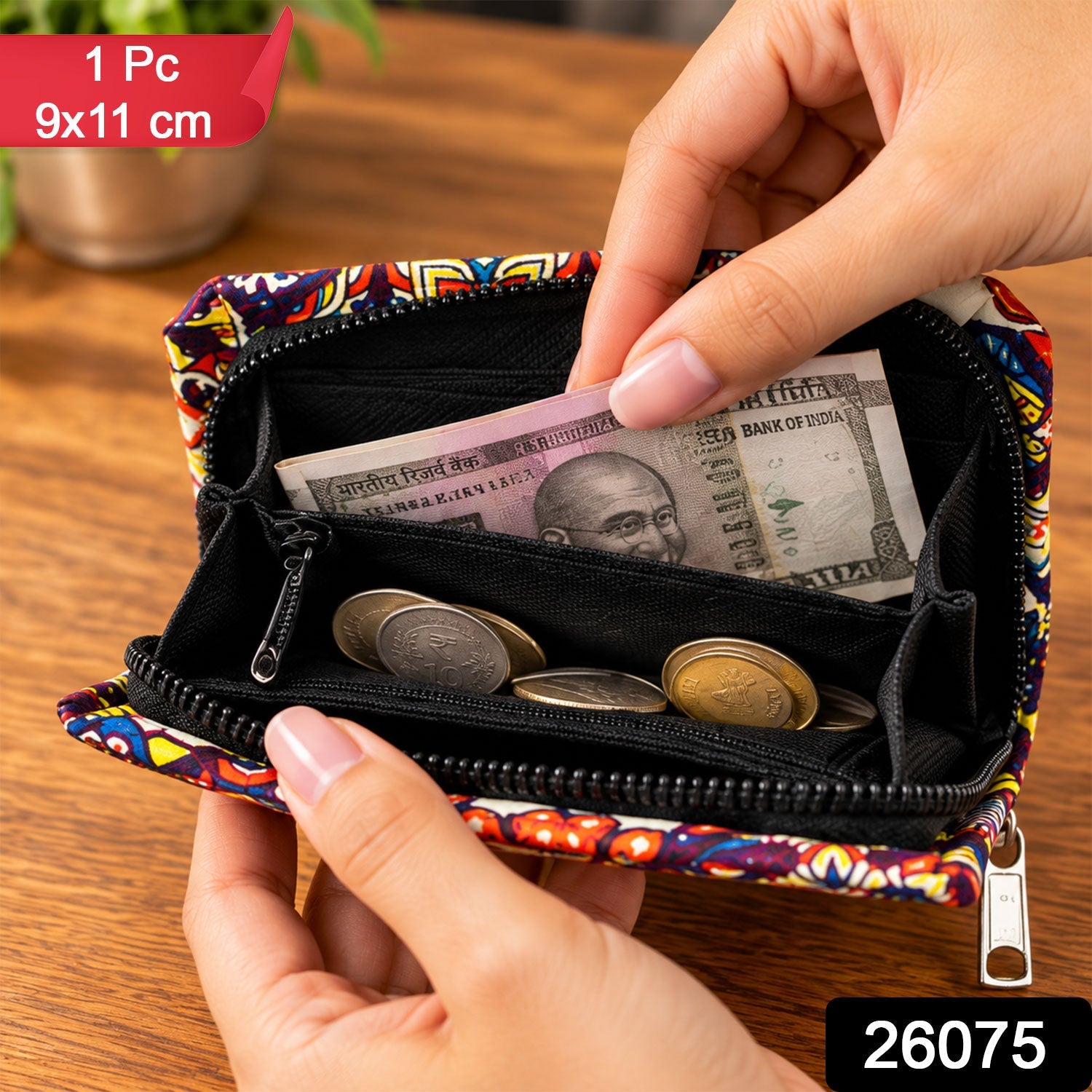 A hand inserts a banknote into the open, vibrant fabric coin purse, revealing a collection of coins within its compartments.